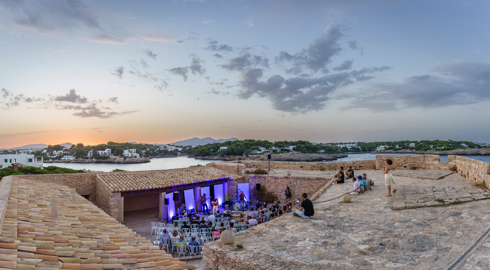 a group of people sitting on a roof of a building