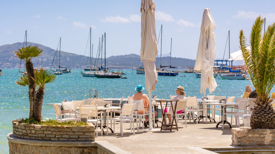 people sitting at tables on a patio