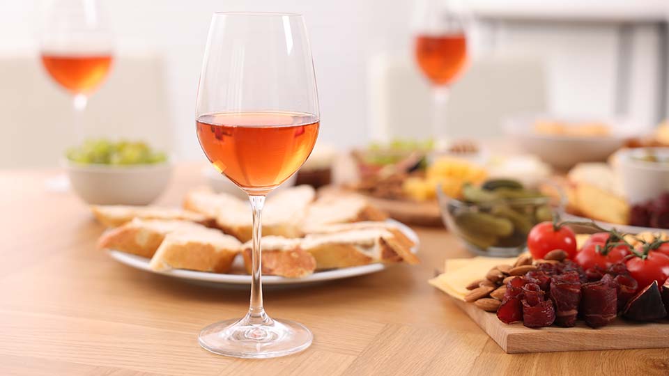 a table with food and glasses of wine