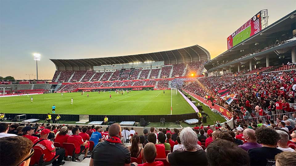 a football stadium with a field and players on the field