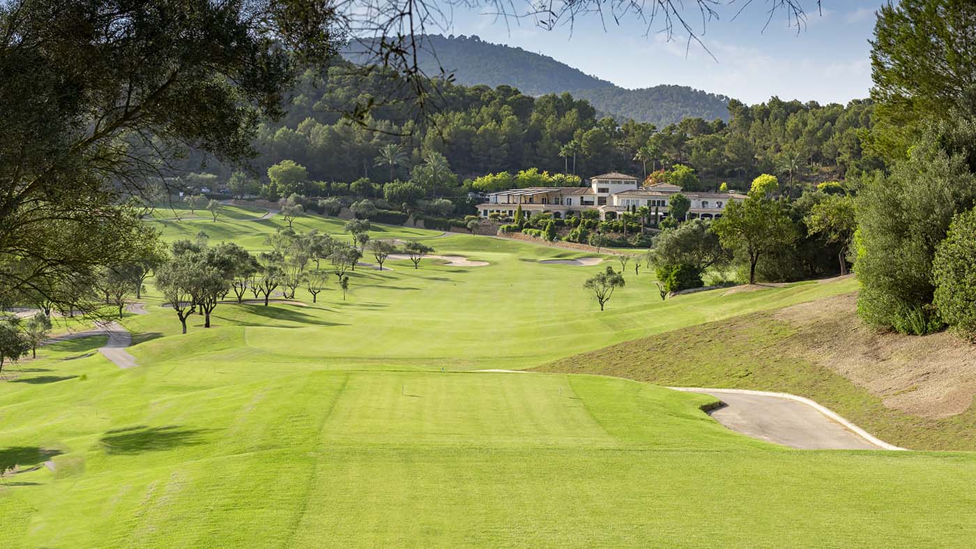 a golf course with trees and buildings