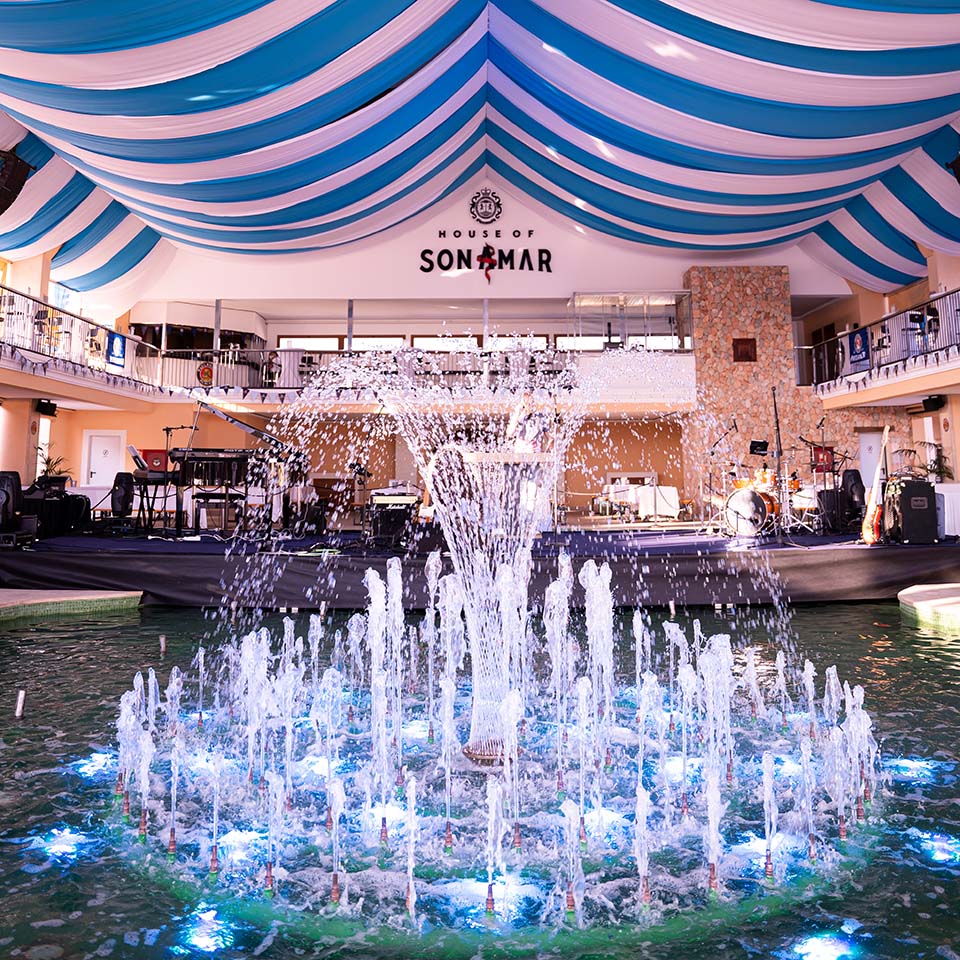 a fountain with water in front of a building